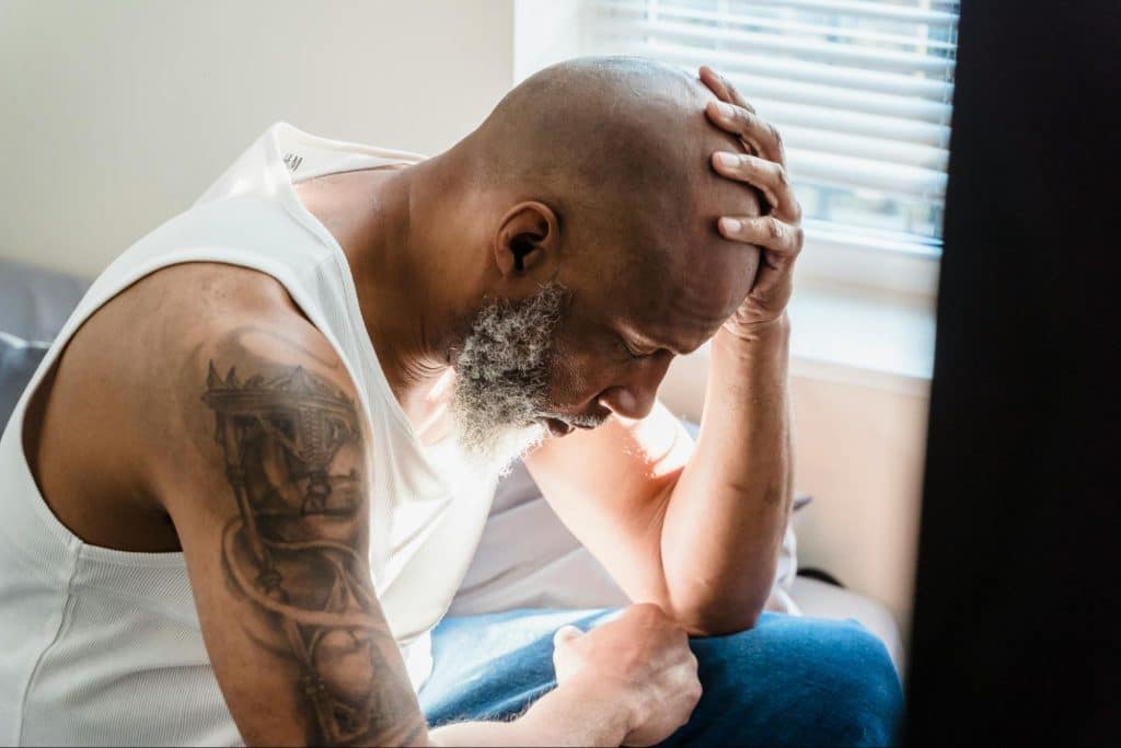 A man holding his head
