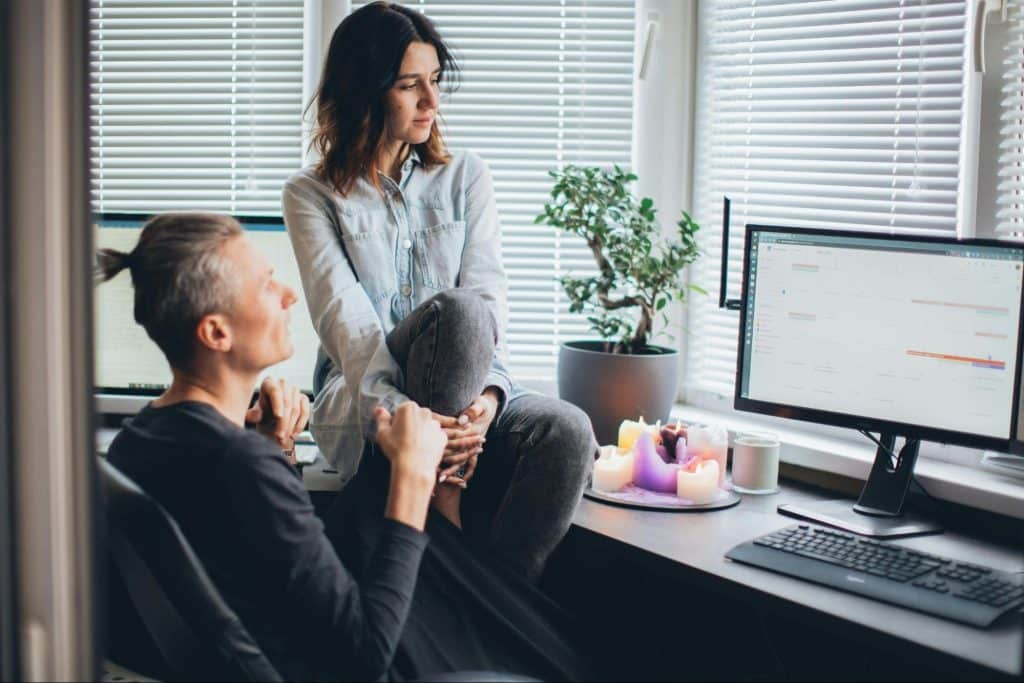 A man and woman looking at the laptop
