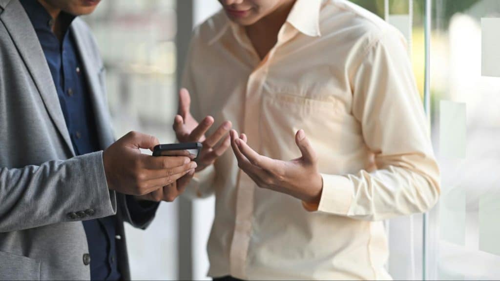 Two men looking at the phone