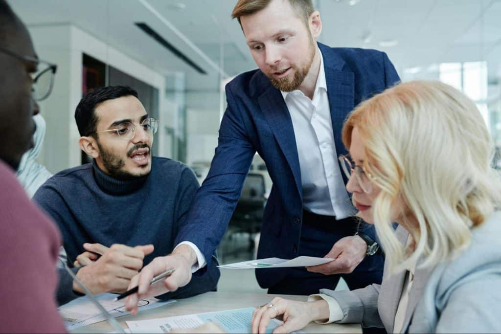 A man talking to his colleagues