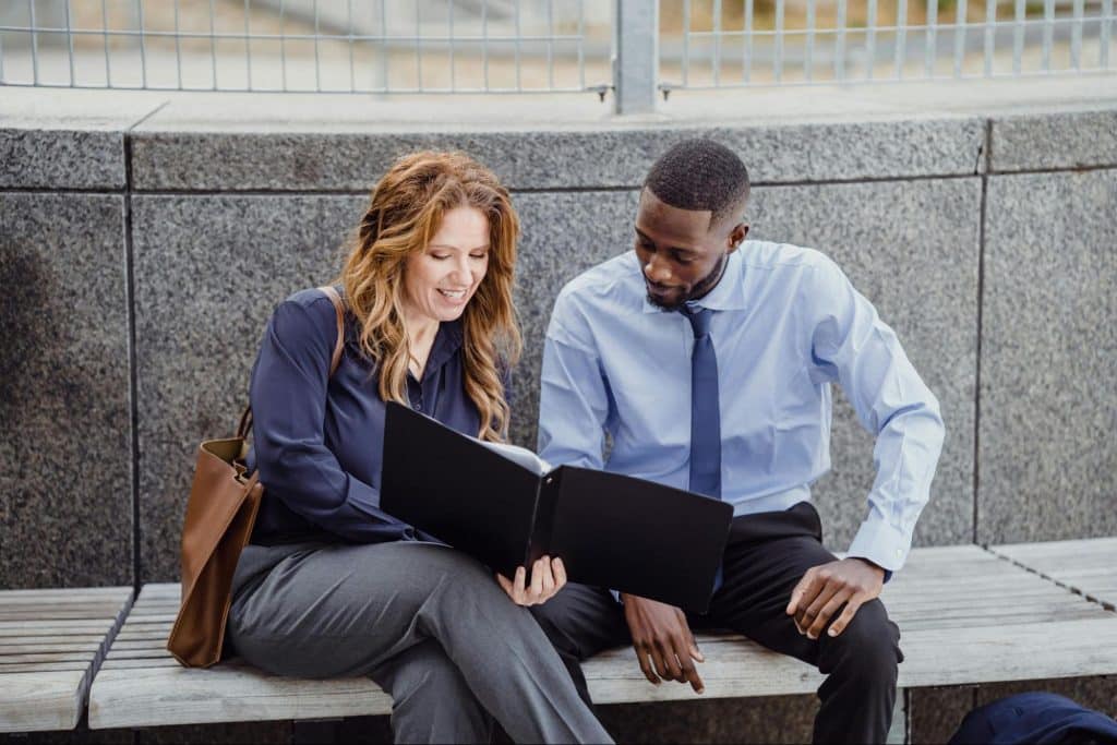 A man just looking at what the woman showing to him
