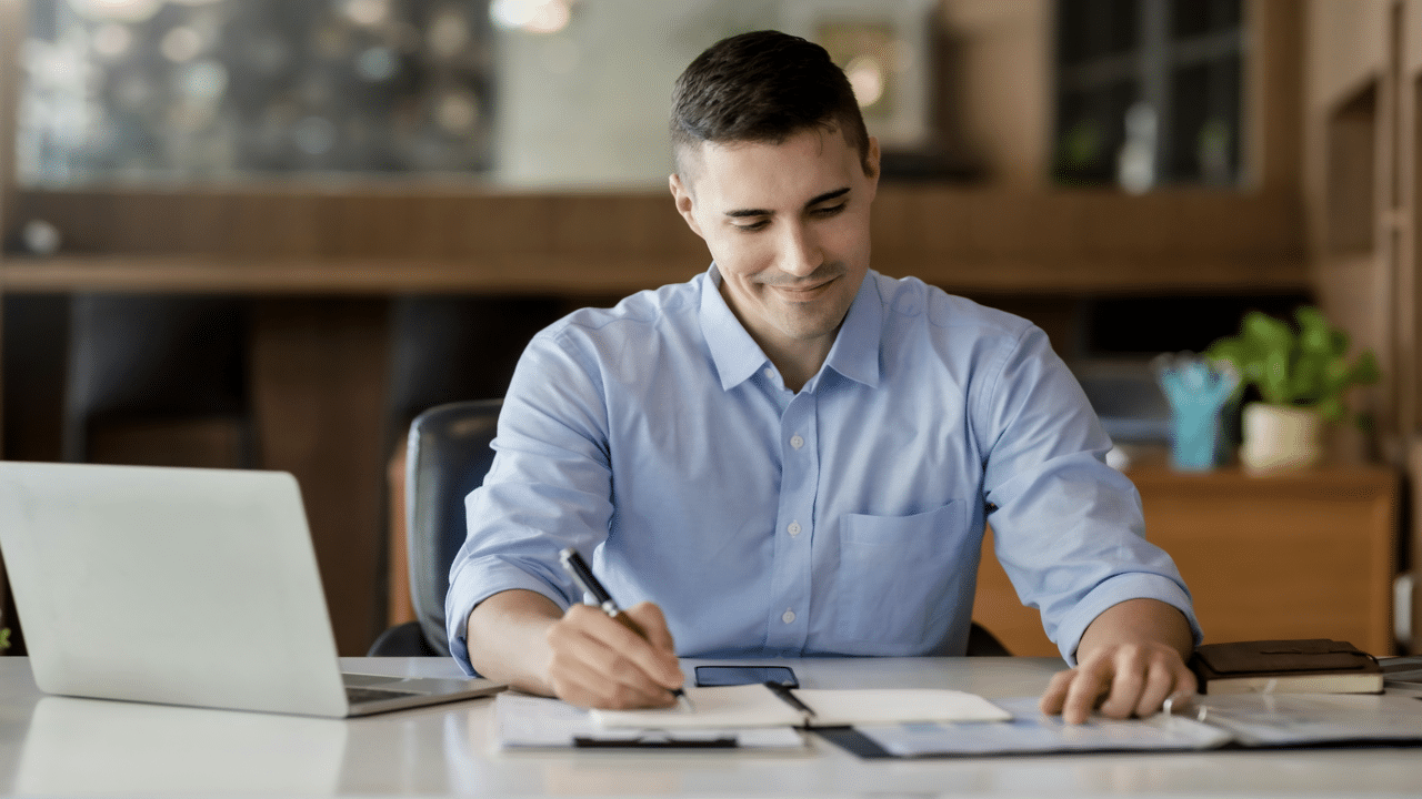 A man taking notes while studying