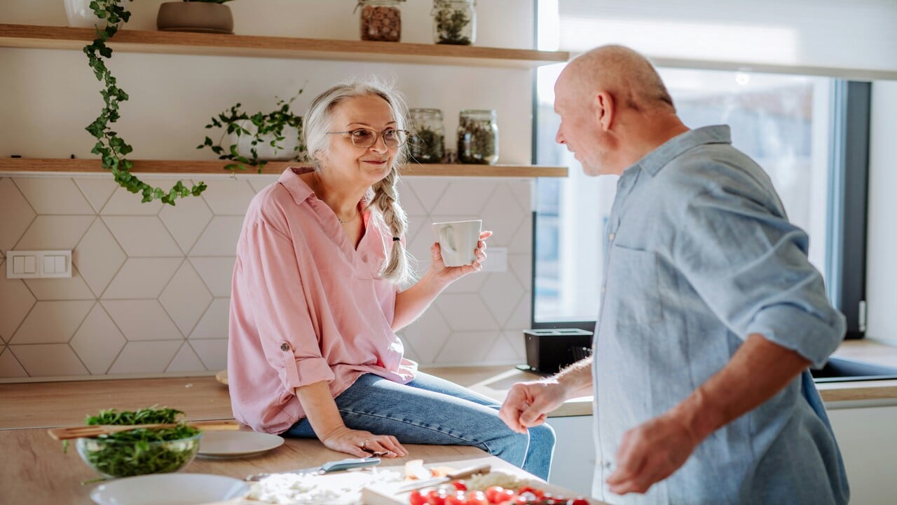 A couple talking in the kitchen
