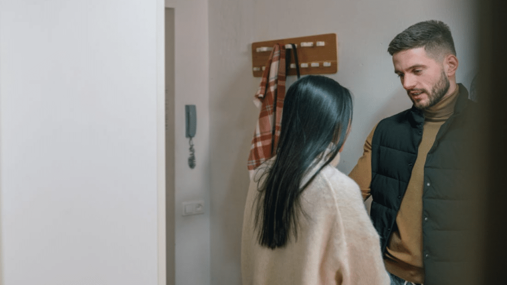 A couple having a serious talk by the entryway