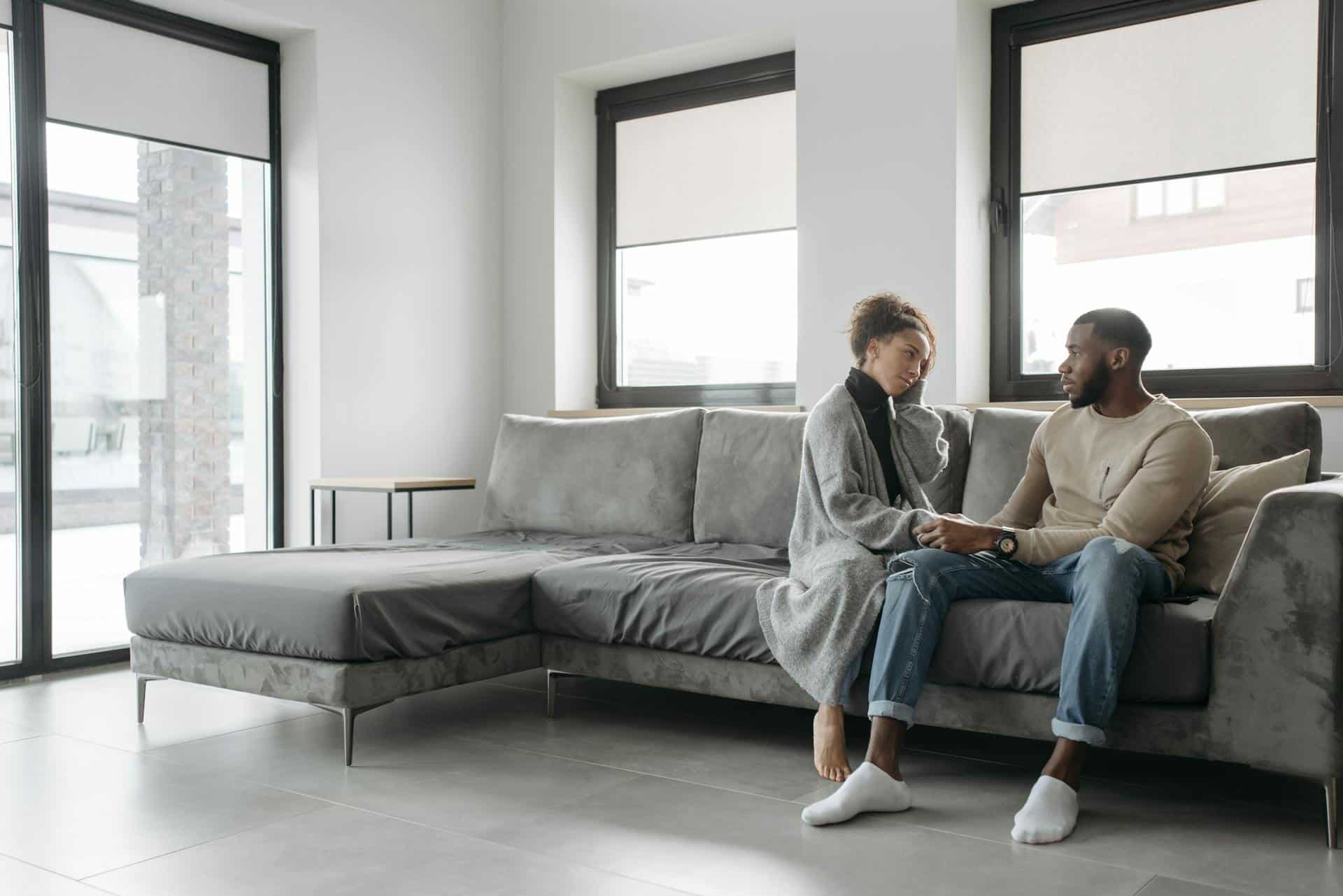 A couple talking on a sofa