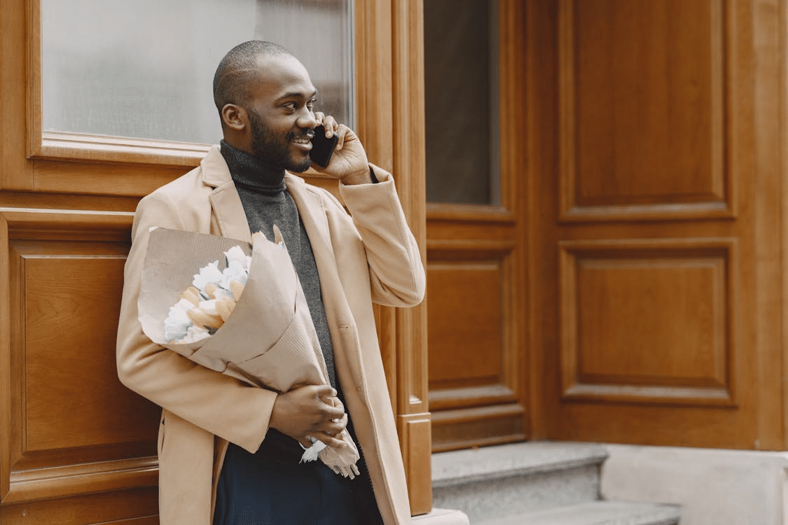 A man holding a bouquet of flowers