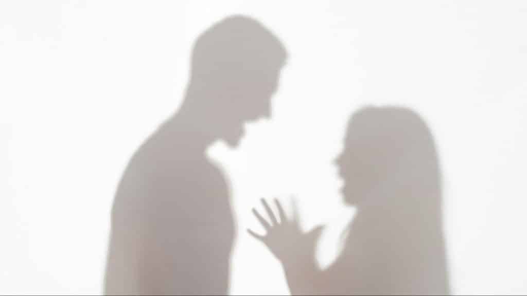 A shadow of a man and woman fighting