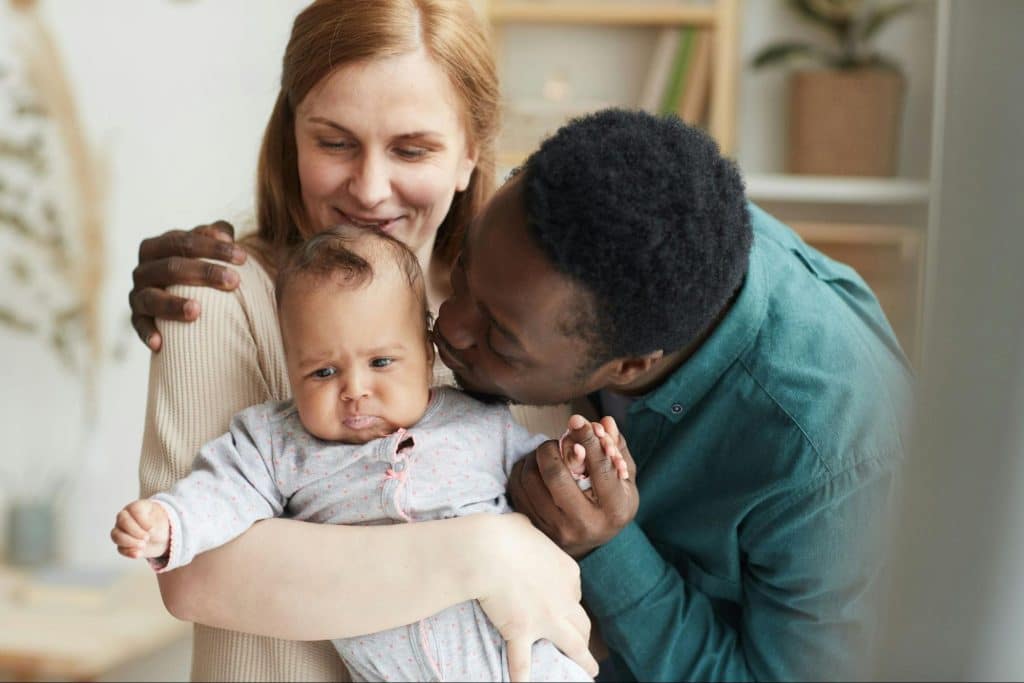 A man and woman with their baby