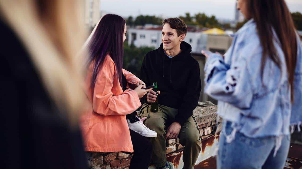 A group of people hanging out together outdoors.