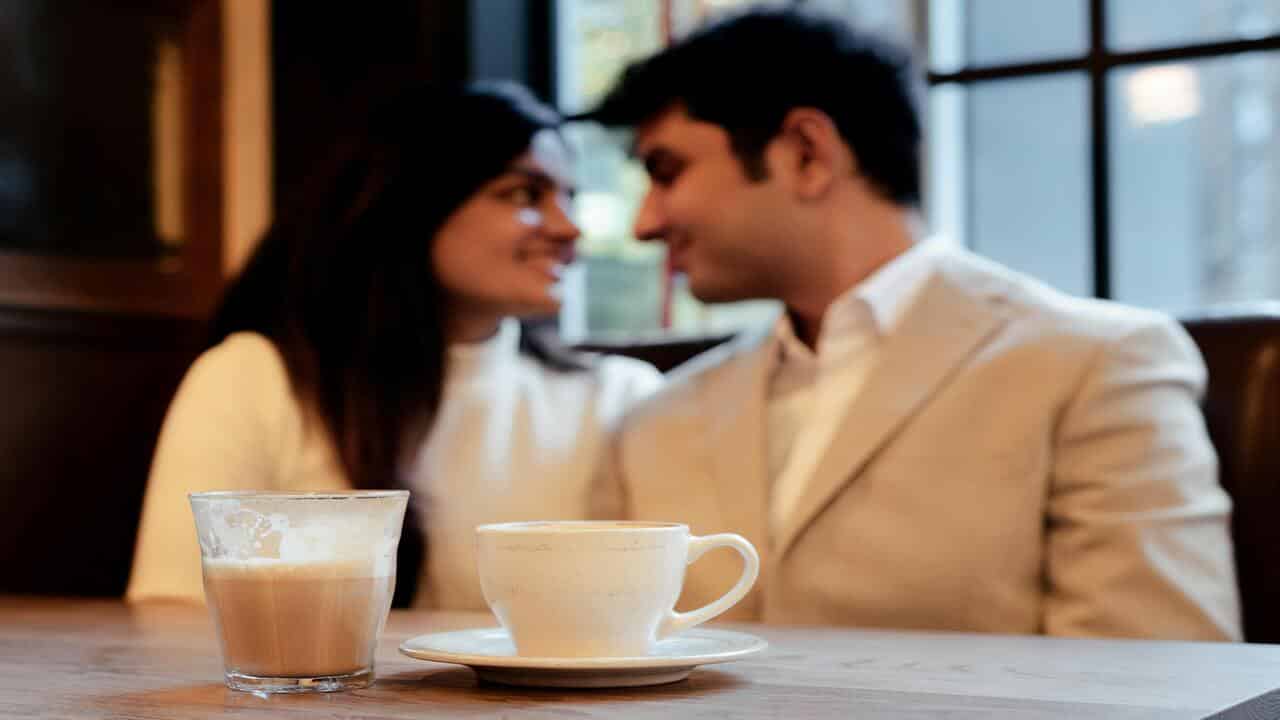 A couple looking at each other during a coffee date