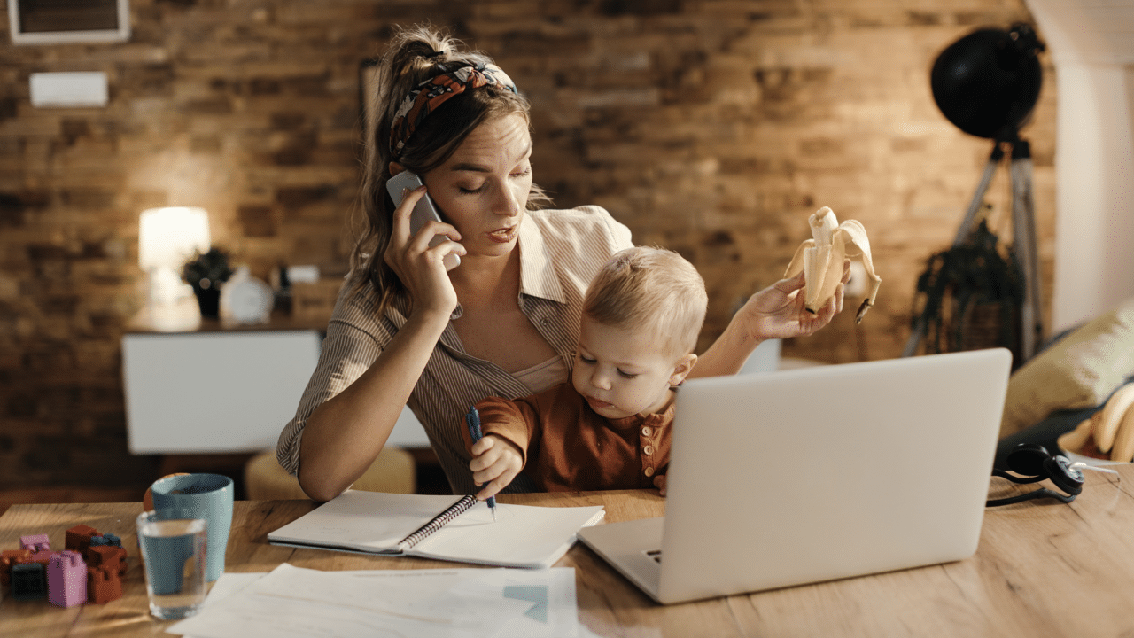 A mom working while taking care of her baby