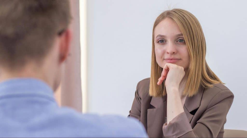 A woman looking at the man