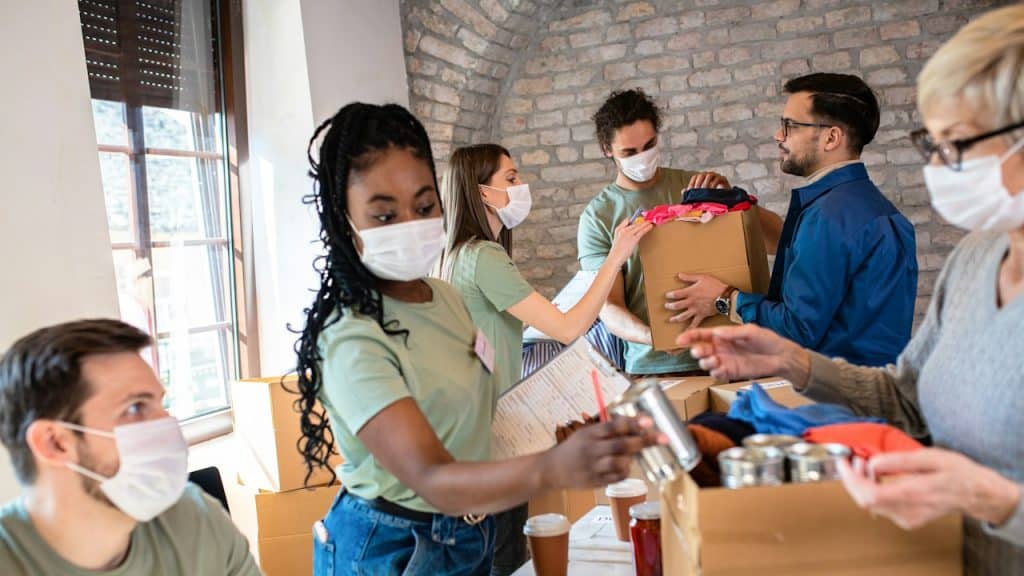 A group of volunteers sorting food and clothes.