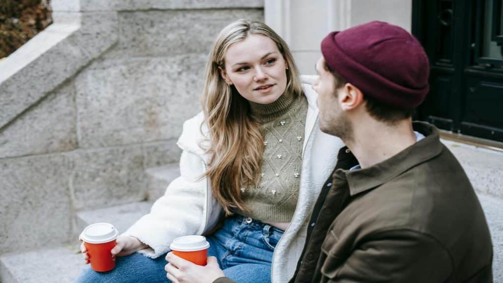 A couple talking by the sidewalk