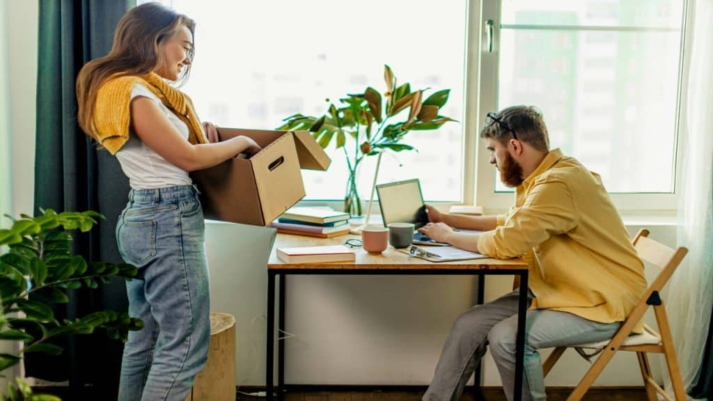 A man helping his wife with her business