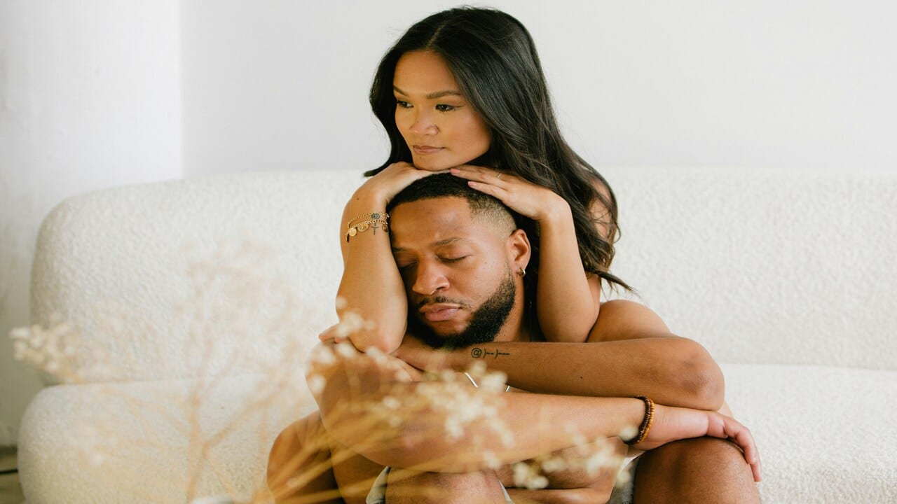 A couple looking sad at home