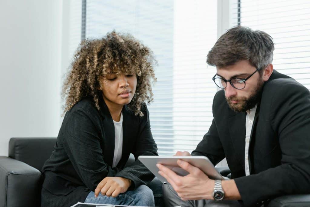 A man teaching something to woman