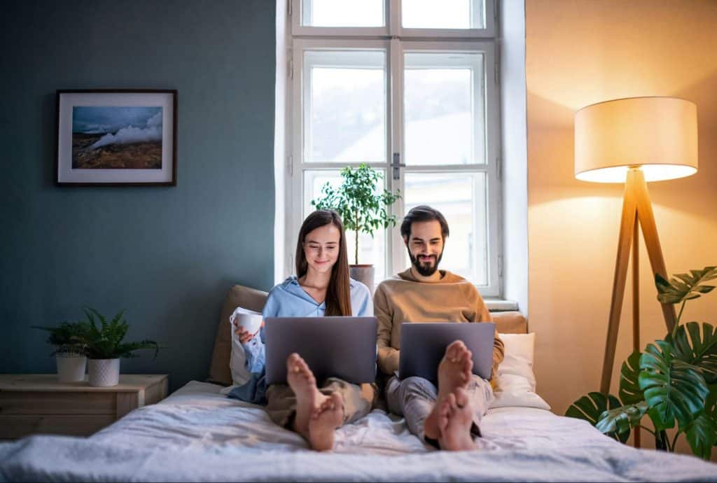 A man and woman at the bed