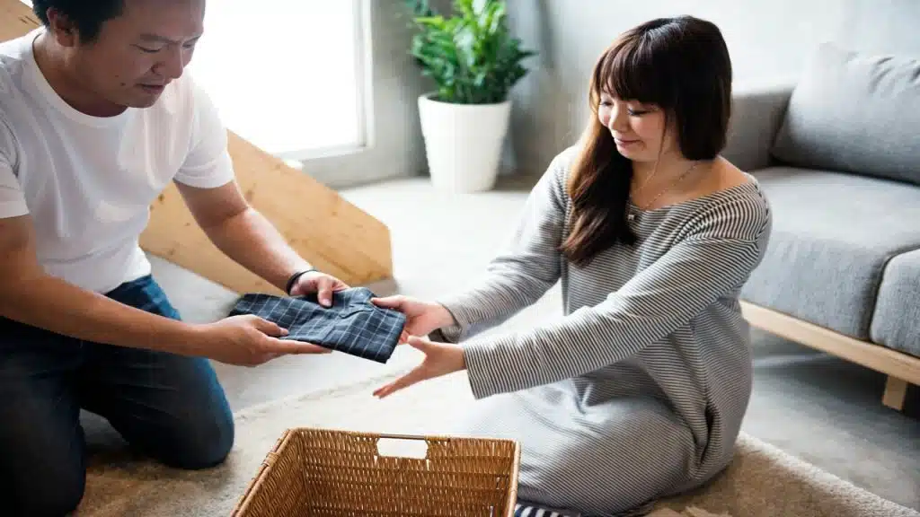 A couple folding clothes together