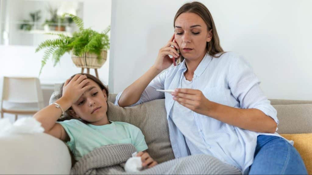 A woman taking care of a sick kid