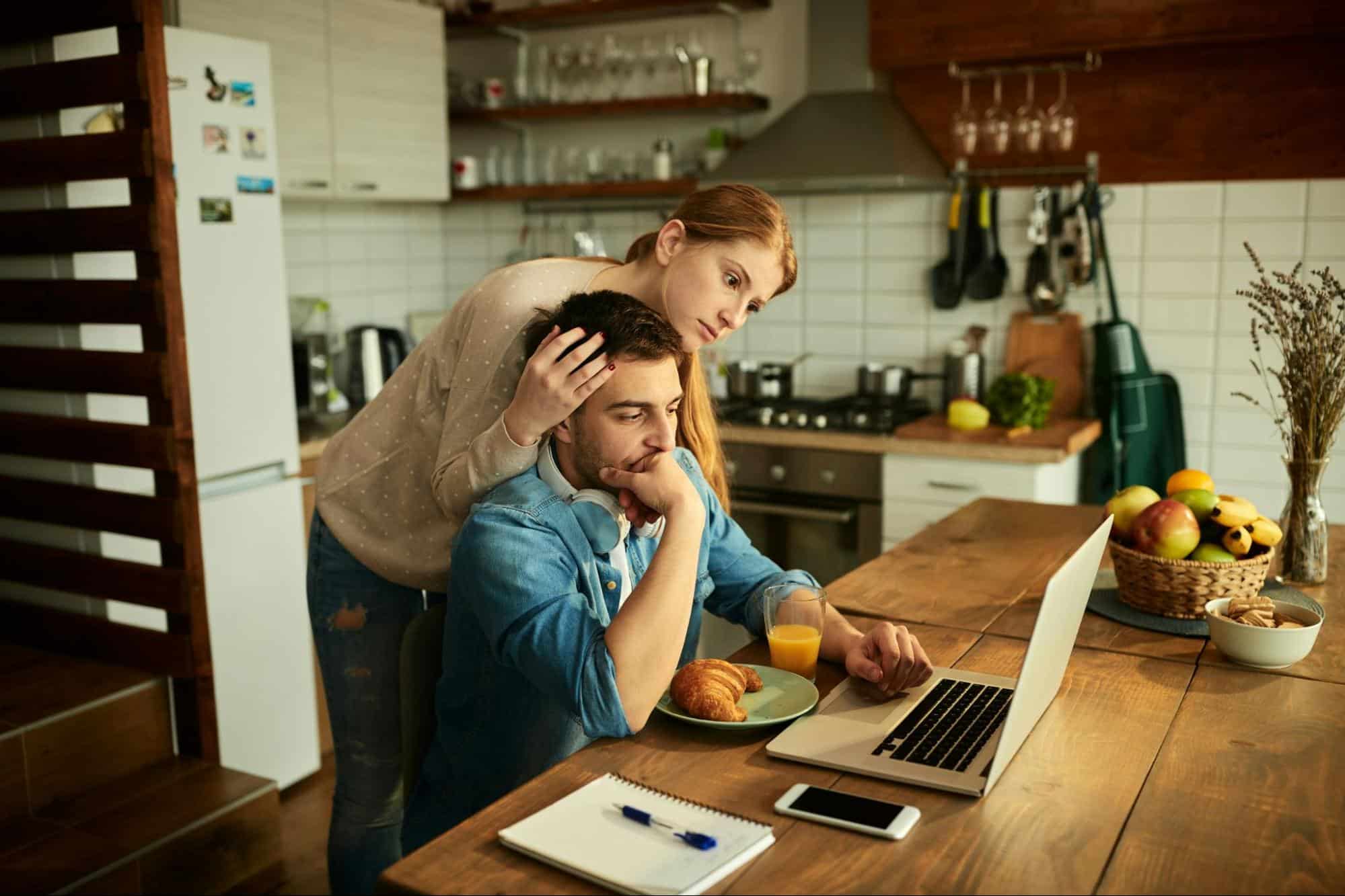 A man looking stressed but not talking to a woman
