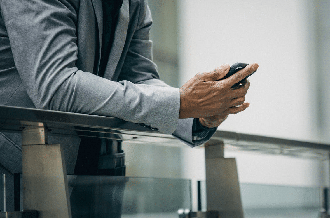 Unrecognizable black entrepreneur using smartphone