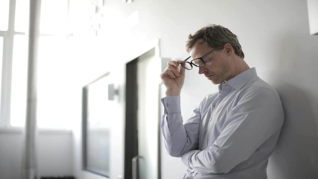 A man looking upset at a hallway