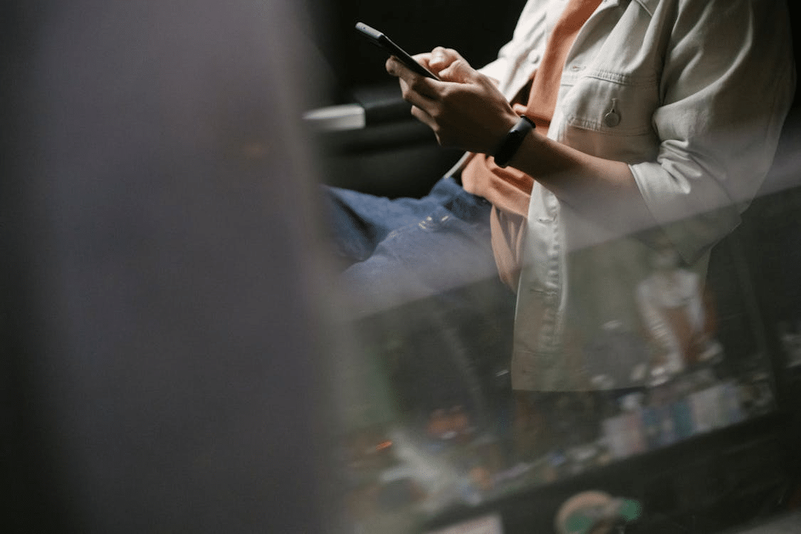 A man texting inside a car
