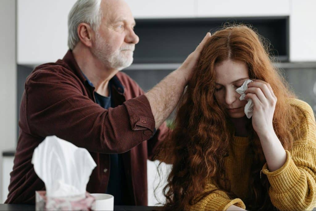 A father comforting her daughter