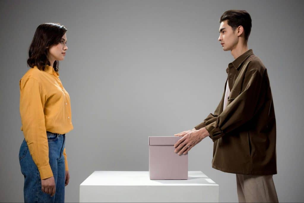 A man opening a box for her
