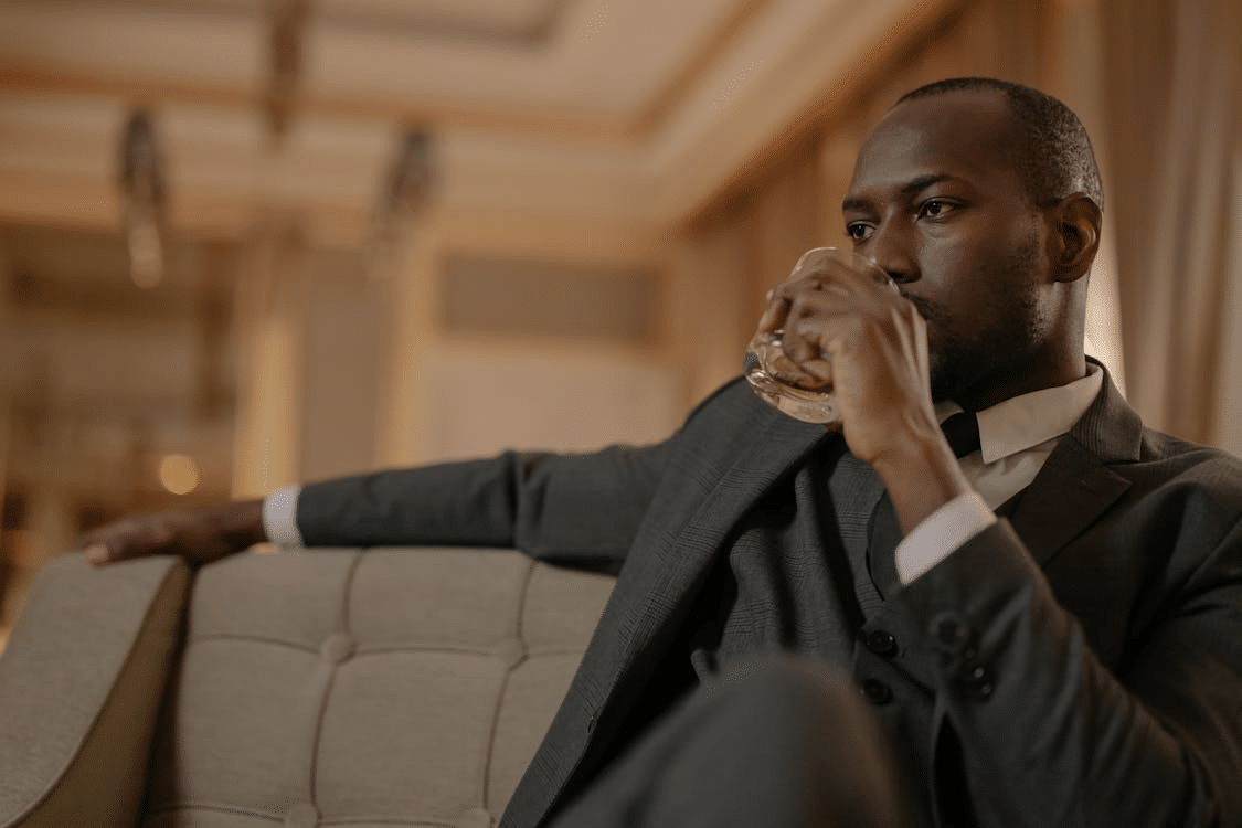 A man drinking whiskey