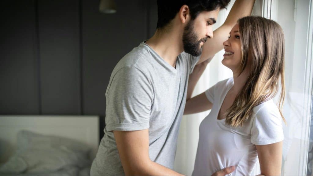 A man and woman smiling at each other