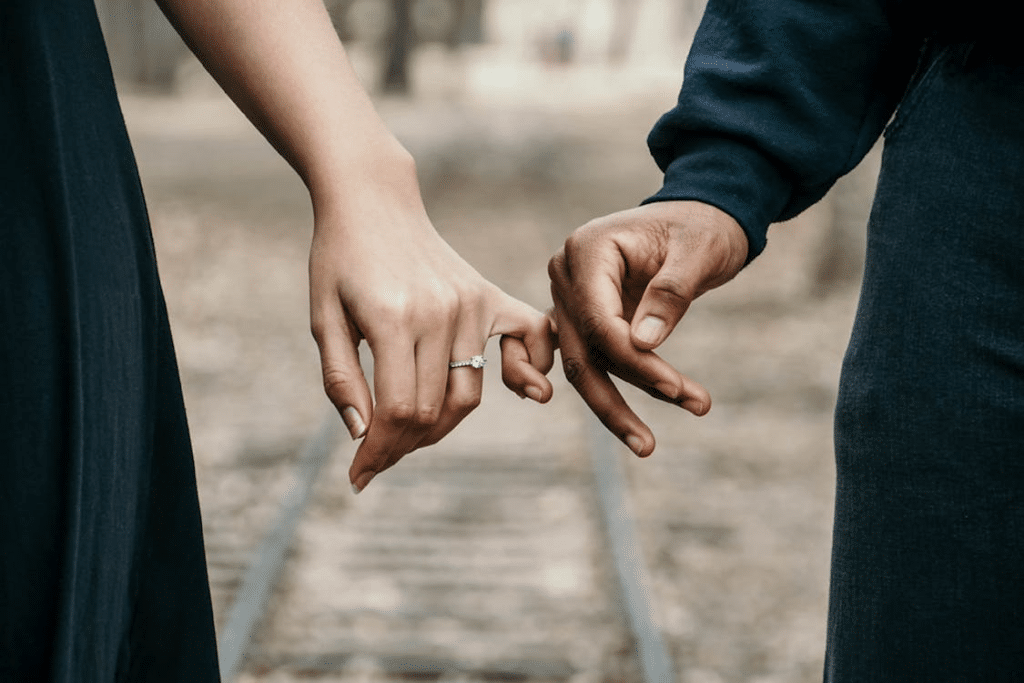 Man and Woman Holding Pinkies