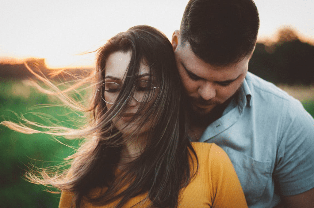 A man standing close to a woman