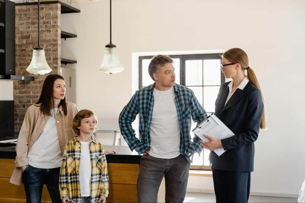 A man talking to woman in front of their kids