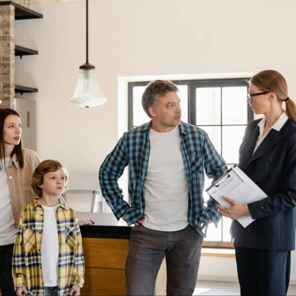 A man talking to woman in front of their kids
