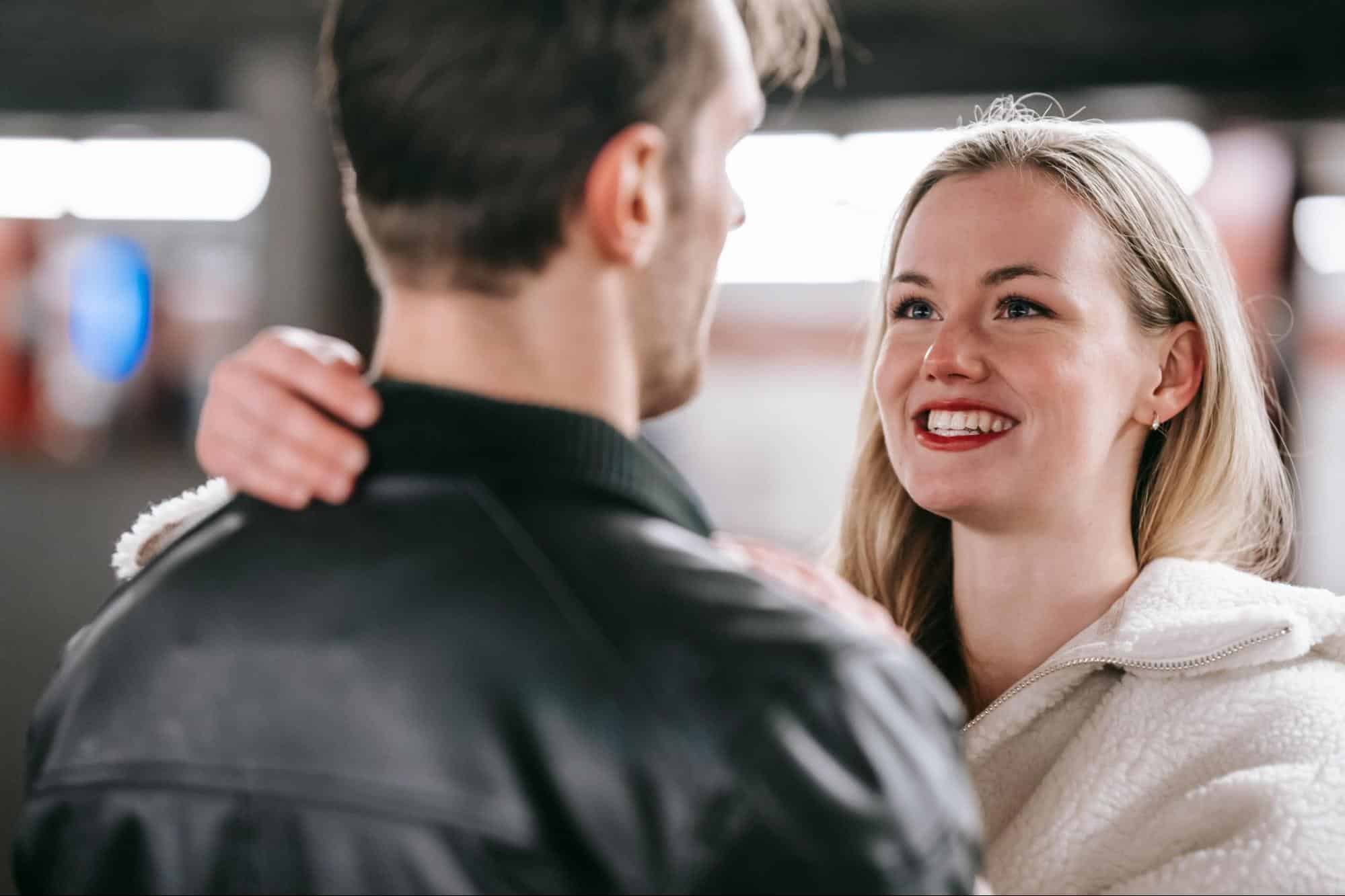 A woman smiling at the man