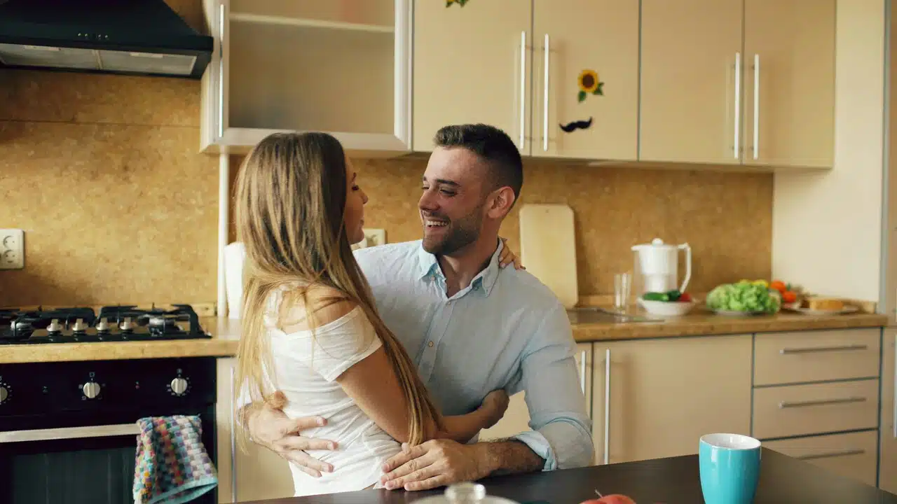 A couple embracing in the kitchen