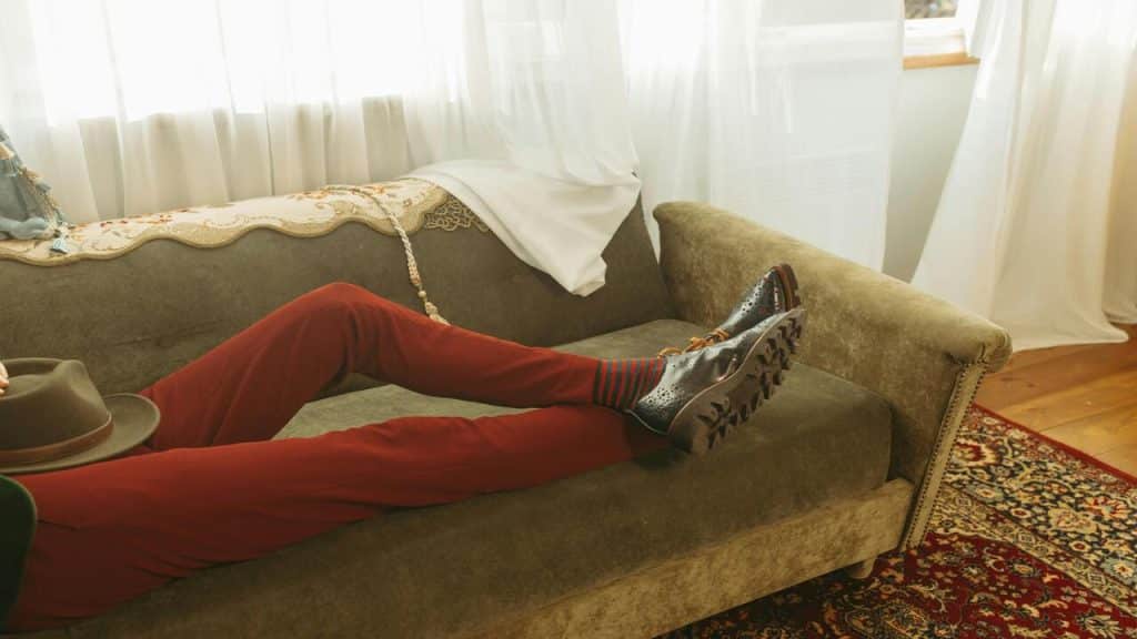 A man laying down on the couch