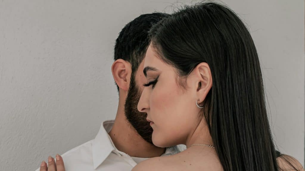 A man and a woman standing close to each other.