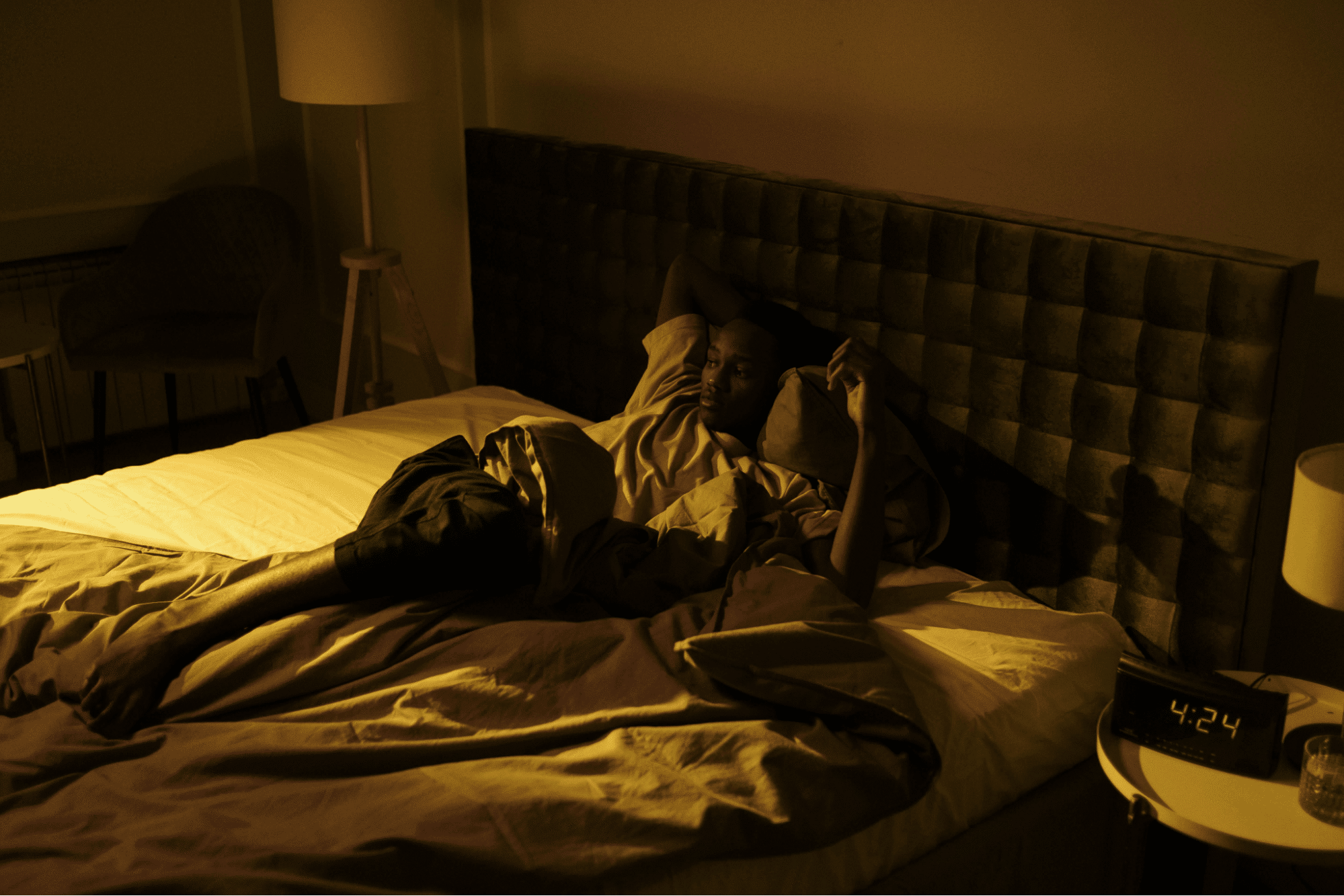 A man in a cozy bedroom