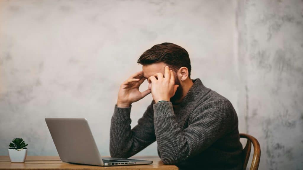 A man looking stressed at work