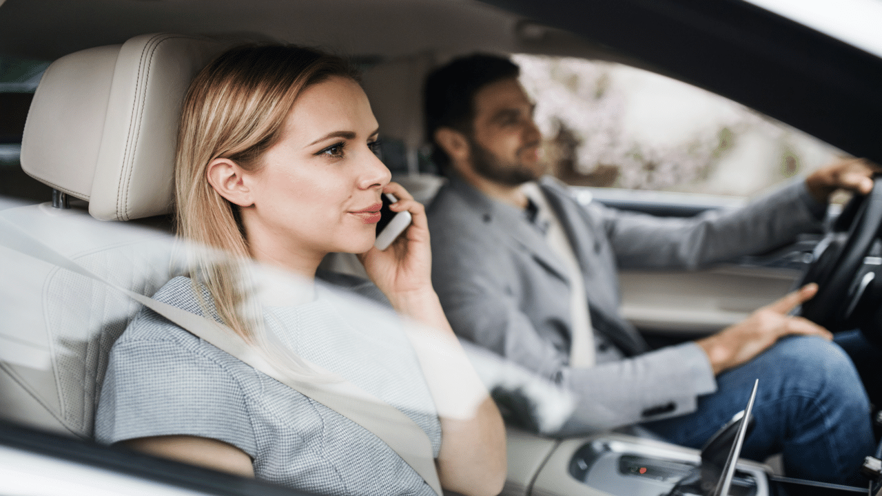 A couple driving to work together