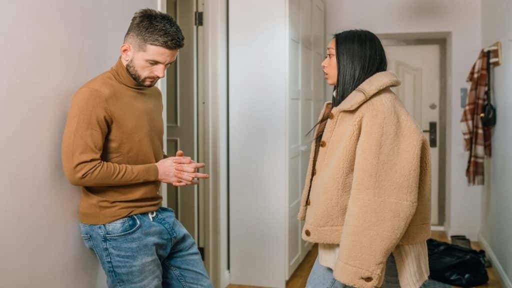 A couple arguing in the entry way