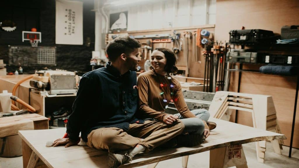 A couple sitting together at a work shop