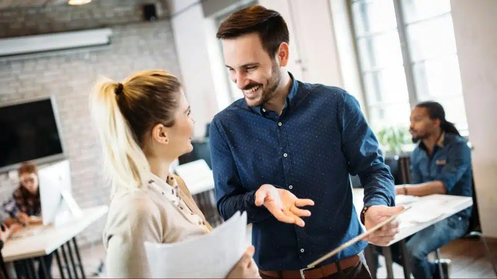 A man complimenting woman for his work
