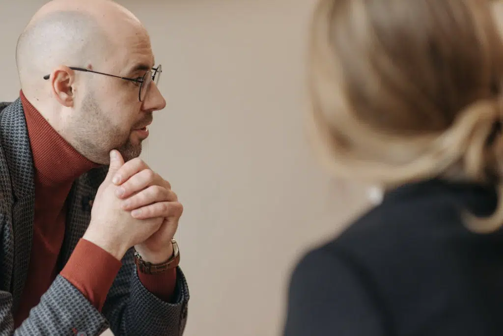 Bald man with eyeglasses looking afar to the right