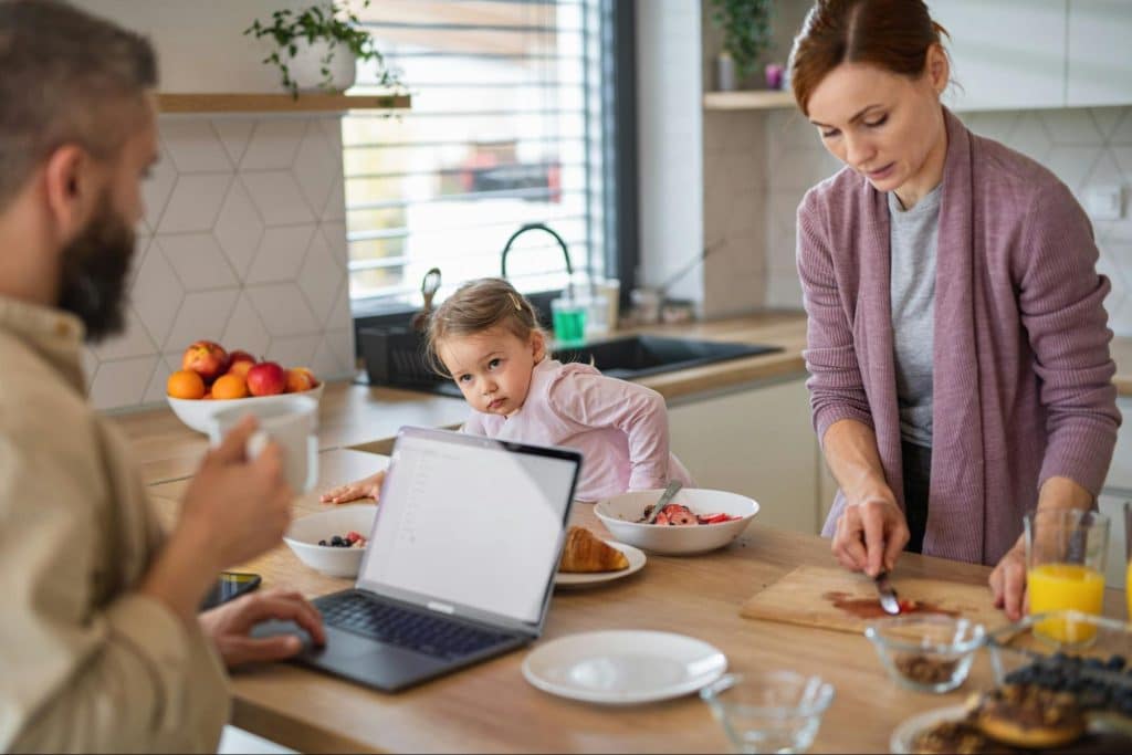 A man working while woman preparing food