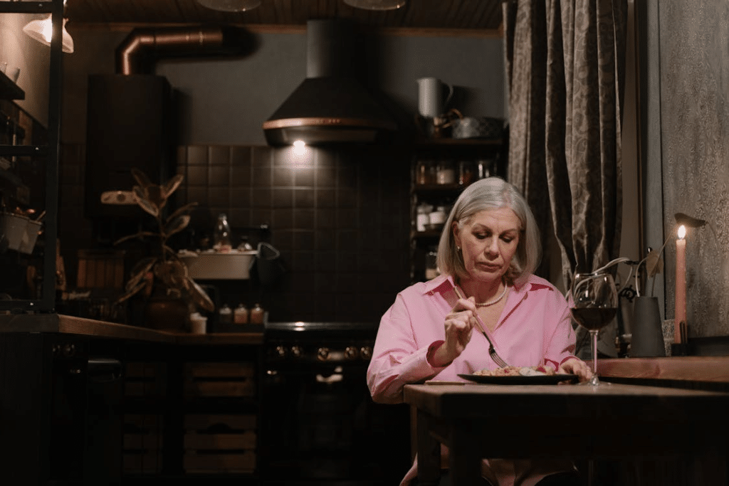 Mature woman eating dinner alone
