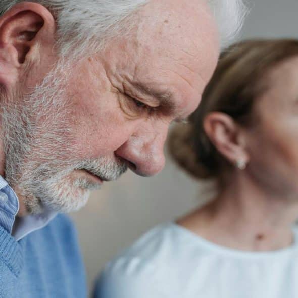 A couple looking upset at home